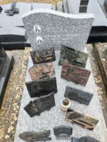 monument gris moucheté avec stèle gravée en lettres blanches, et à gauche des identifications, les photos des 2 défunts - O.Dufour