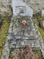 petit caveau en pierre avec stèle forme trapeze sur laquelle est fixée une plaque d'identification.  deux autres plaques d'identification sont fixées sur le mur - O.Dufour